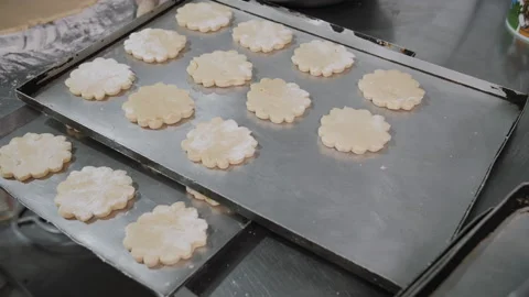 Hand Placing Cookie Dough on Baking Tray. Bakery production. Stock Footage 321363048