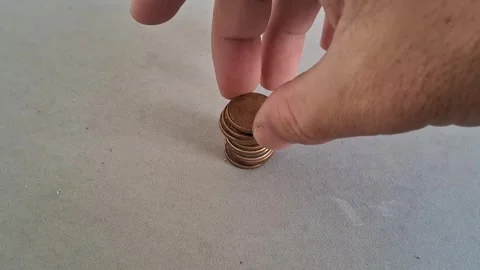 Hand placing copper coin on stack in motion video footage Stock Footage 339247303