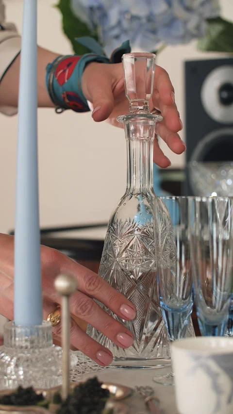 Hand Placing Crystal Decanter on Festive Table Stock Footage 321306819