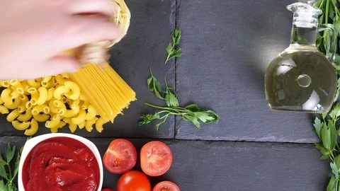 Hand placing different ingredients for dinner preparation Stock Footage 94956990