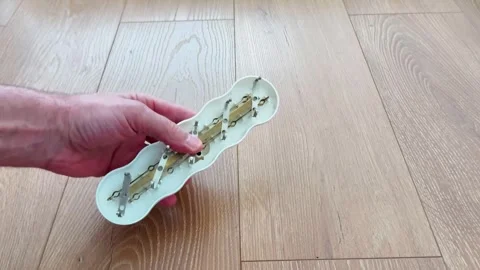 Hand Placing Disassembled Electrical Extension Cord on Wooden Floor 스톡 동영상 328476566