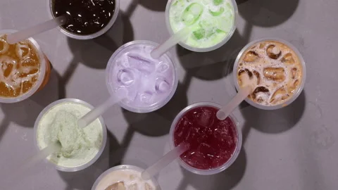 Hand placing down dragon fruit juice beverage onto ice drink pattern. Stock Footage 156197461