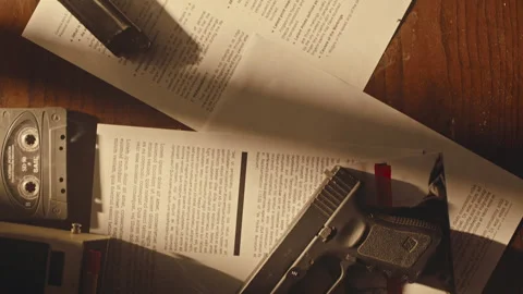 Hand Placing Down Gun on a Detective's Desk Stock Footage 274640617