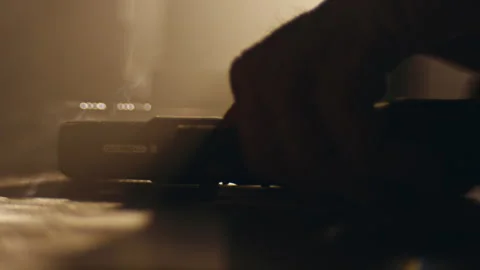 Hand Placing Down Gun on the table Stock Footage 274571443