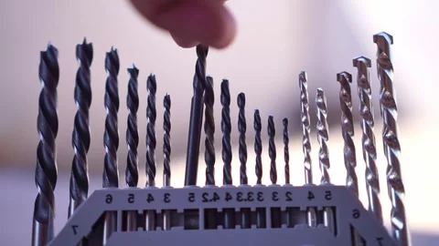 Hand placing drill bit into storage case, organized tool set, workshop Stock Footage 345869640