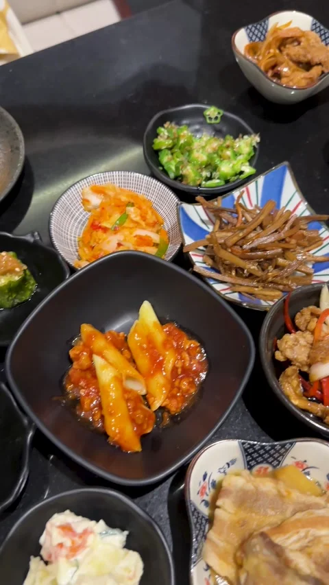 Hand Placing Egg Yolk Over Japanese Side Dishes in Bangkok Izakaya Stock Footage 341905419