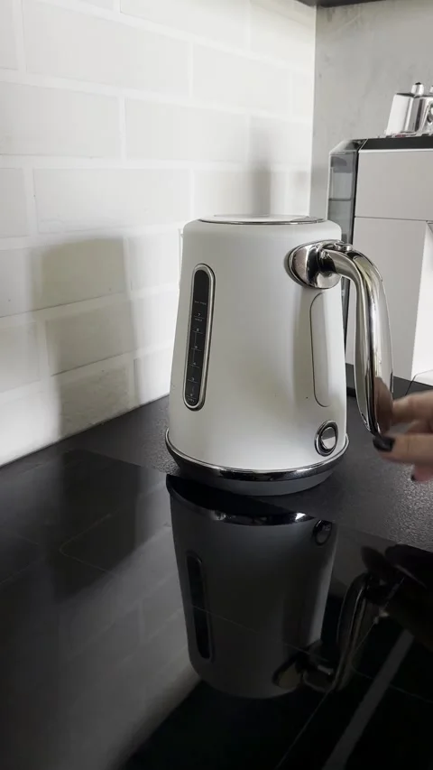 Hand Placing Electric Kettle on Base and Switching It On Stock Footage 340138216