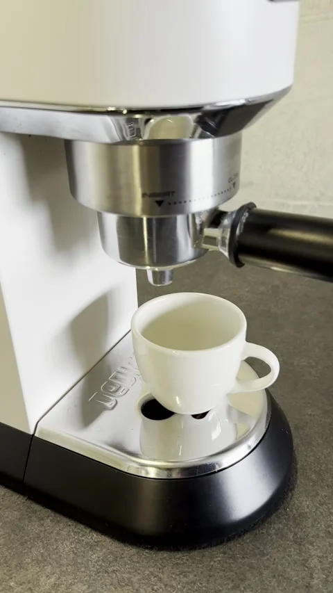 Hand Placing Espresso Cup Under Coffee Machine as Fresh Coffee Brews Stock Footage 340138265