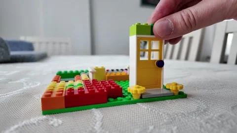 Hand Placing Final Green Block on Toy House - Completion Concept Vídeo Stock 332413548