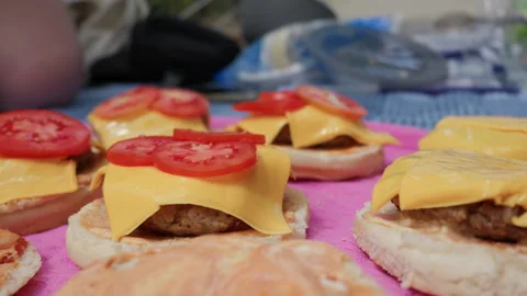 Hand Placing Fresh Tomato Slice on Homemade Cheeseburger Assembly Stock Footage 341999668