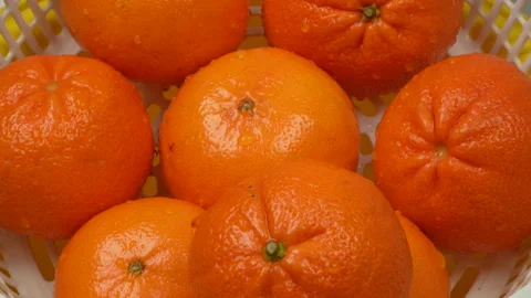 Hand Placing Fresh Washed Oranges in White Basket Close Up 4K Stock Footage 319436993