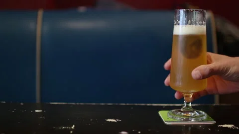 Hand Placing Glass Of Beer On Coaster At Table Vídeo Stock 344848080