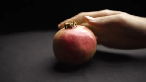 Hand Placing a Grenade on a Dark Background Stock Footage 272184652