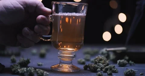 Hand Placing Marijuana Infused Tea 4k 120p Stock Footage 229010087