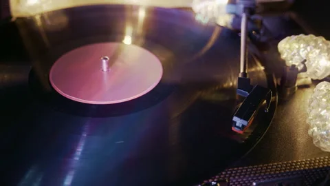 Hand Placing Needle on Spinning Vinyl Record in the Evening Stock Footage 345399141