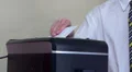A hand placing paper in shreader HD Footage