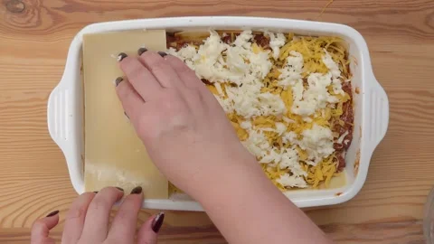 Hand placing pasta sheet on lasagna mold. Stock Footage 293131039