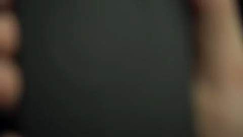 Hand placing phone on wireless charging station from first person. Back side of Stock Footage 314465211
