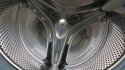 Hand Placing Sheets Inside White Washing Machine, Close Up, Dolly Out Stock Footage 133050641