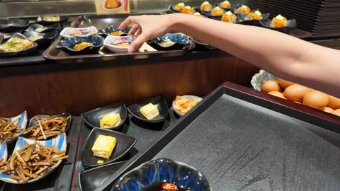 Hand Placing Shoyu Pickled Egg Yolk on Tray in Bangkok Restaurant Stock Footage 340245275