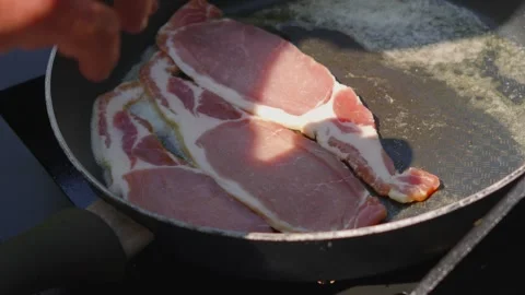 Hand Placing Slices of Bacon in Pan. Stock Footage 341663861