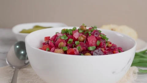 Hand placing a spoon next to a bowl of vinaigrette salad Stock Footage 320611151