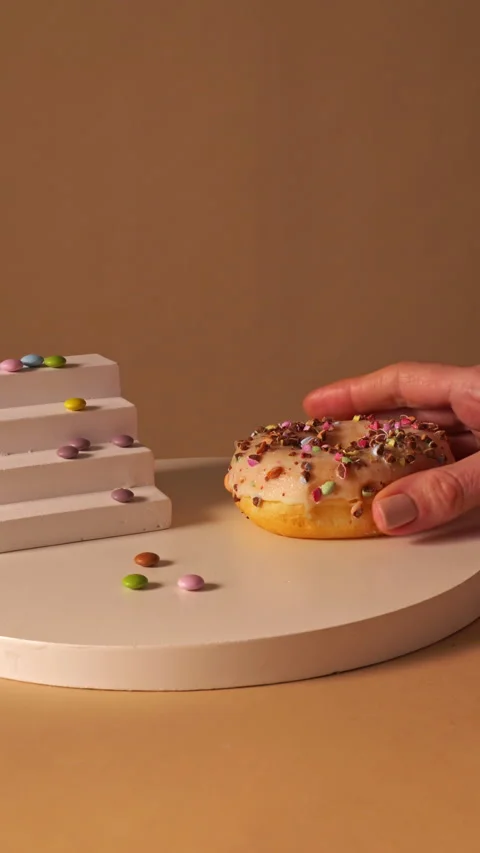 Hand Placing Sprinkle Donut Down on Mini... | Stock Video | Pond5