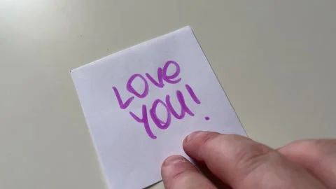 Hand Placing Sticky Note with Love You Message Close Up Stock Footage 340214550