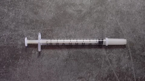 Hand placing a syringe Stock Footage 278920728