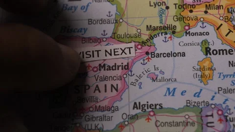 Hand placing visit next text tag on map over Spain destination travel concept Stock Footage 346745124