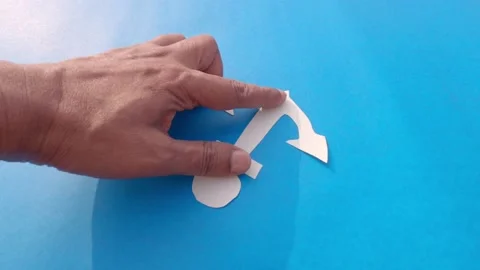 Hand Placing White Anchor on Isolated Blue background. Nautical theme. Copy S Stock Footage 170171510