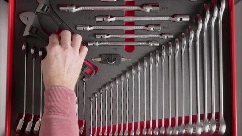 Hand placing wrench back into organized tool drawer Stock Footage 327783574
