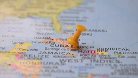 Hand Placing Yellow Pin on Cuba Location in World Map Stock Footage 333567825