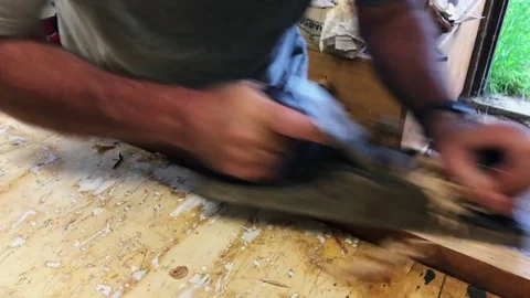 Hand planing timber with a 100year old plane Stock Footage 84473912