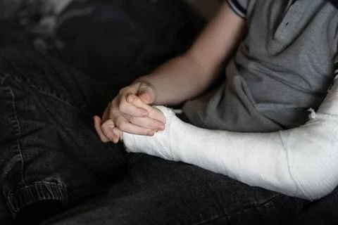 Hand in a plaster cast Stock Photos