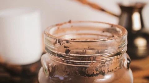 Hand with plastic scoop scooping cocoa powder from jar in kitchen Stock Footage 120336322