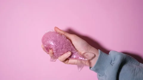 Hand play with Squeeze pink fish Hand Wrist Exercise Antistress Toy. Stress Stock Footage 164932464