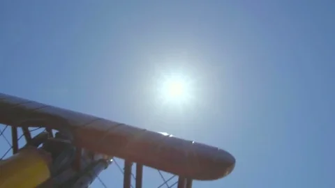 The hand play with a wood plane on the background of a bright sun Stock-Footage 75265352