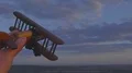 The hand play with a wood plane on the background of a bright sunset 4k or 4k+ Resolution