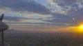 The hand play with a wood plane on the background of a bright sunset 4k or 4k+ Resolution