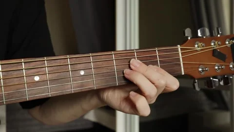 Hand Playing Acoustic Guitar Close-Up, studying fretboard details, performe.. Stock Footage 292625341