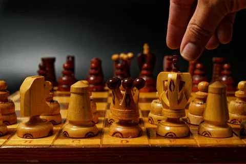 Hand playing chess Stock Photos