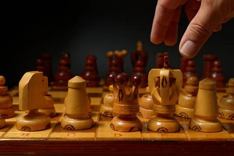 Hand playing chess Stock Photos