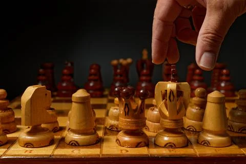 Hand playing chess Stock Photos