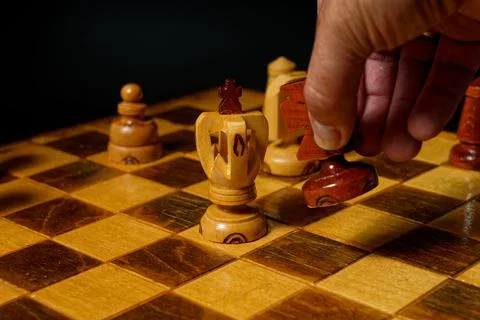 Hand playing chess Stock Photos