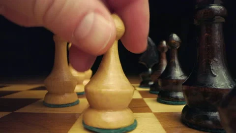 Hand playing chess while camera is moving between pieces on chessboard macro Stock Footage 149375146