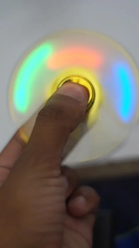 Hand Playing With Colorful LED Light Spinner Toy - Vertical Footage Stock Footage 340357634