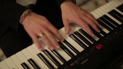 Hand playing on digital piano. Close-up. Small depth of field. Black and white Stock Footage 71370708