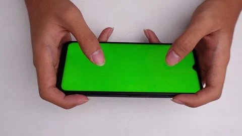 Hand playing game on green screen smartphone isolated white background Stock Footage 270685864