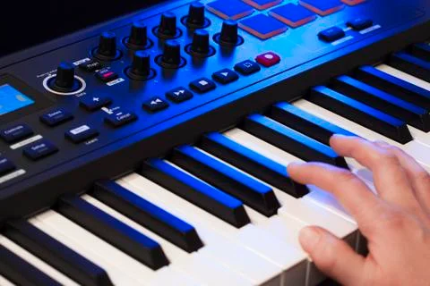 Hand playing a midi keyboard Stock Photos